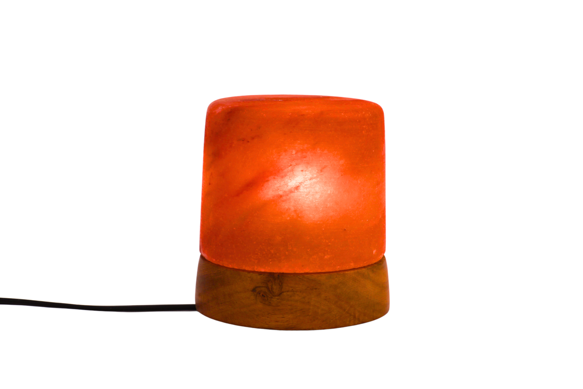 Small lamp with orange shade and wooden base on a white background